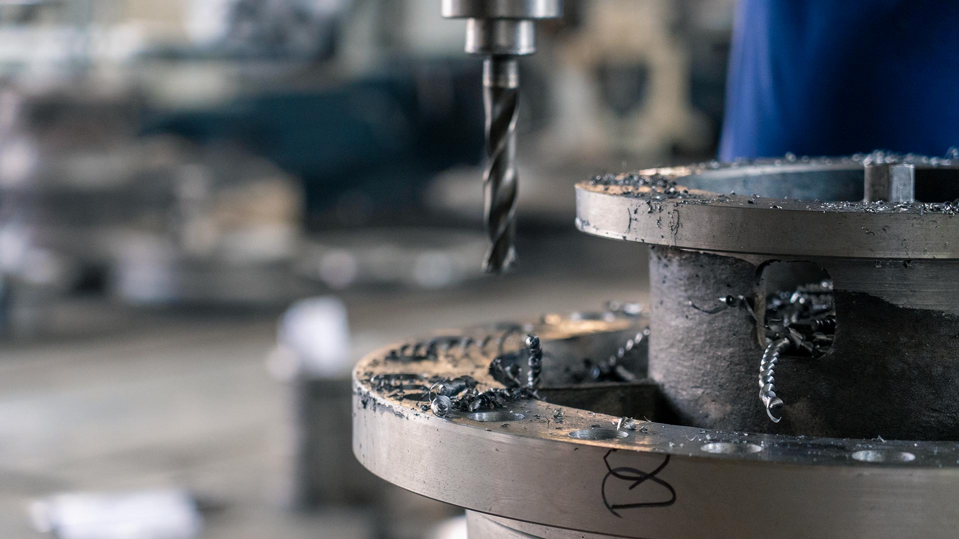Precision machining workshop — drilling a metal flange